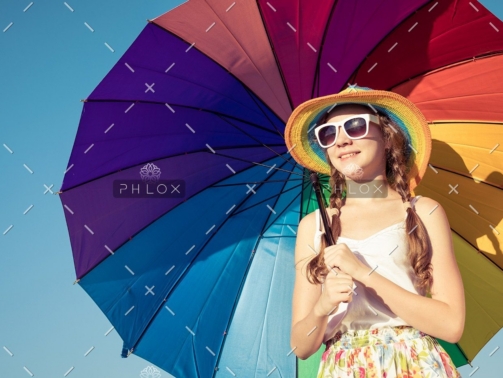 demo-attachment-35-teen-girl-with-umbrella-standing-on-the-beach-at-PMEQ6S8